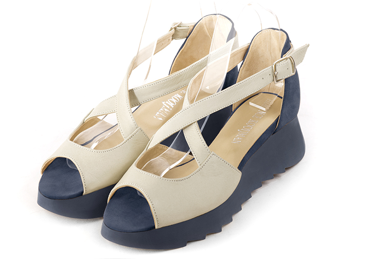 Off white and denim blue women's closed back sandals, with crossed straps. Round toe. Low rubber soles. Front view - Florence KOOIJMAN